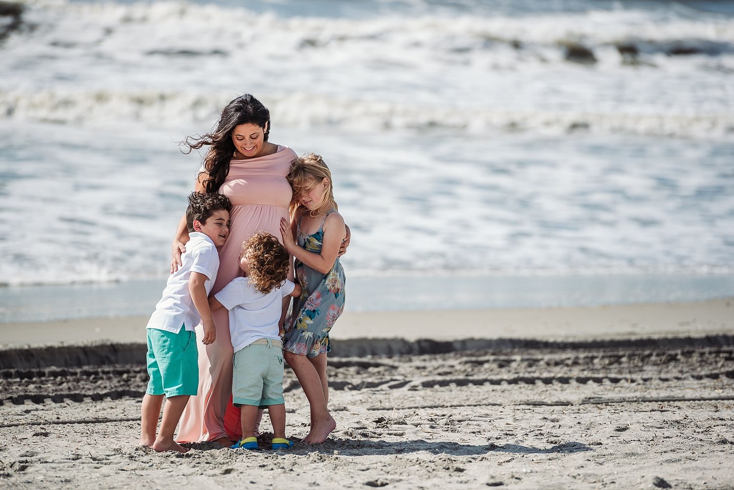 Family playing and bonding together on a sunny beach.