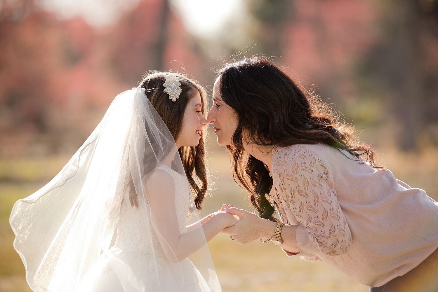 An intimate moment shared between two people during a wedding photoshoot in autumn.
