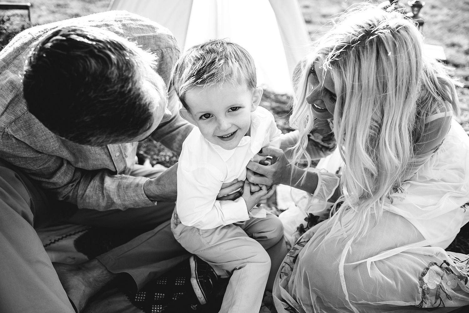 A candid black and white moment of joy shared during a picnic outdoors.