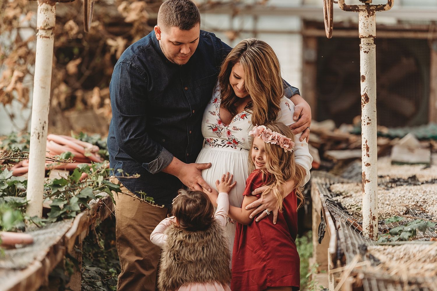 A tender family moment captured outdoors in warm autumn light.
