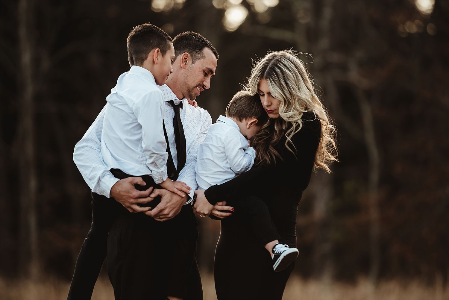 A joyful family moment captured in dramatic lighting outdoors.