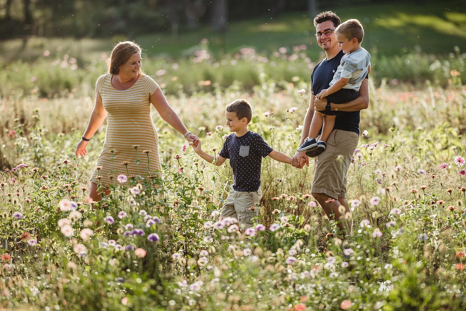 Group walking together through a summer meadow filled with delicate wildflowers.