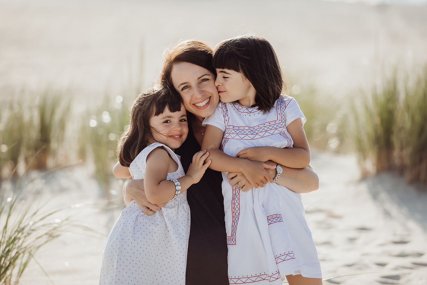 A heartwarming beach scene with embracing figures against sandy dunes.