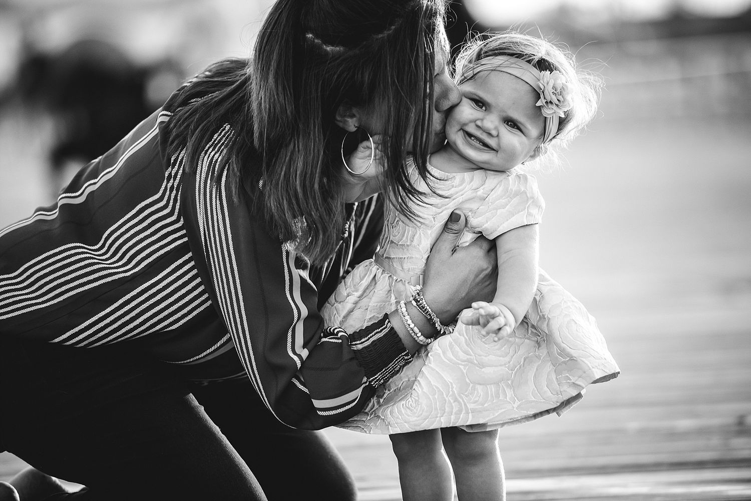 A touching moment captured in black and white of parent and child sharing laughter.