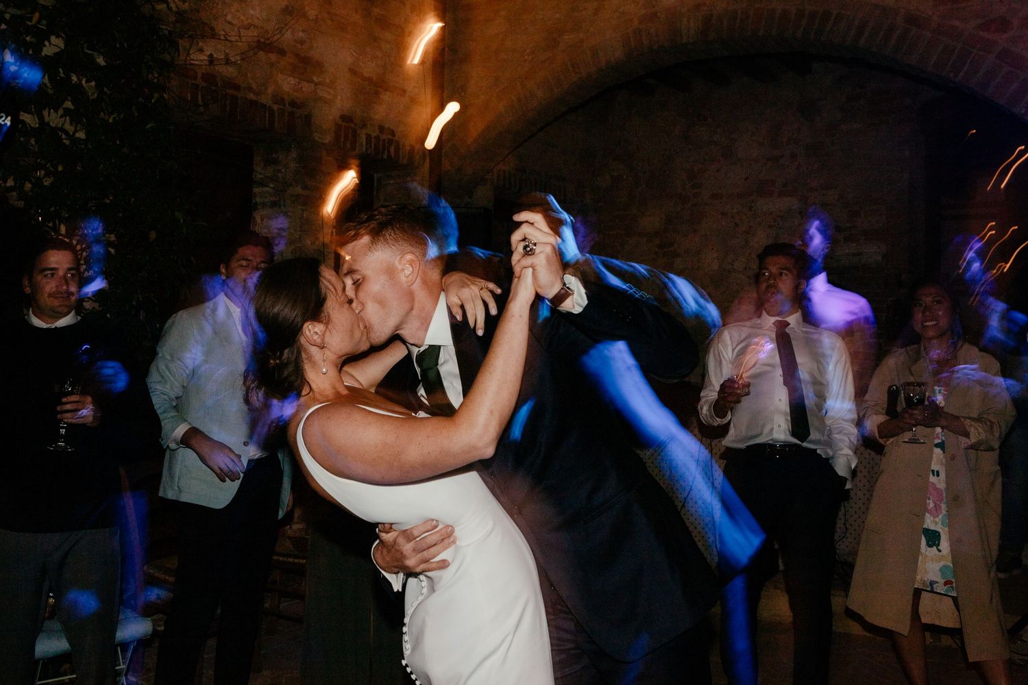 A kiss between during the first dance at The Lazy Olive wedding venue in Tuscany.