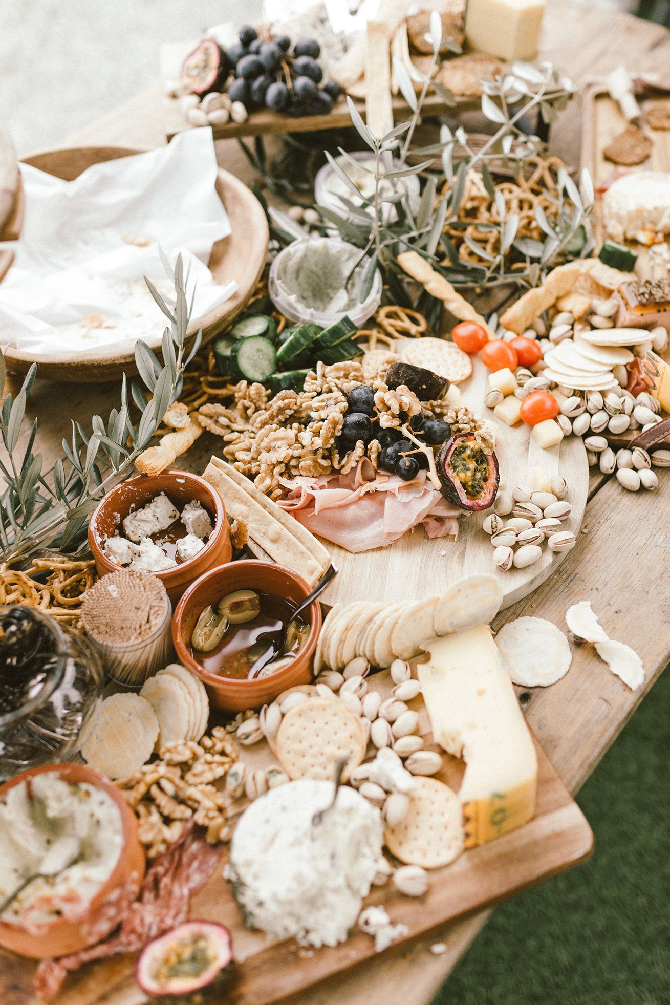 Gourmet charcuterie board with cheese, fruits, nuts and appetizers for wedding reception.