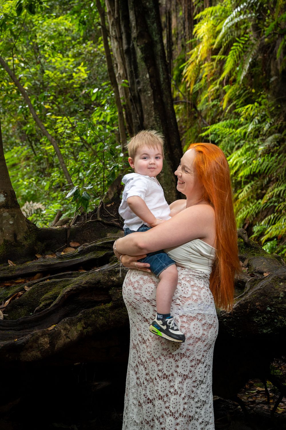 Pregnant mum holding her son on her baby bump