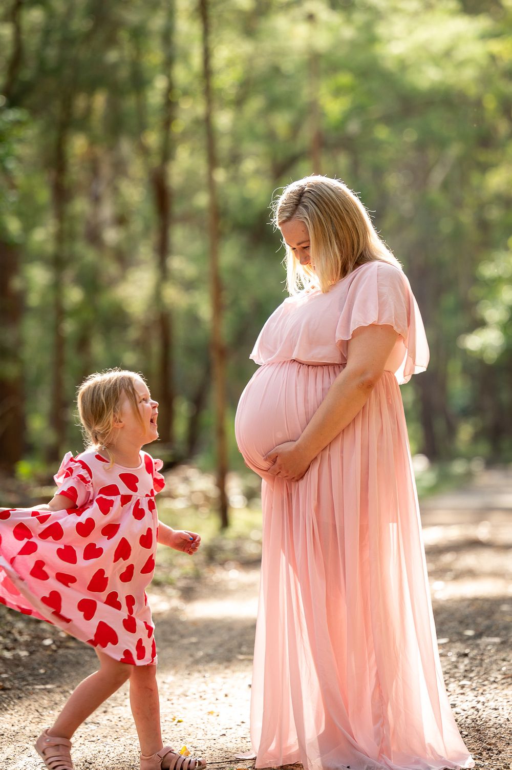 Mum to be playing with her niece during her maternity shoot in the bush