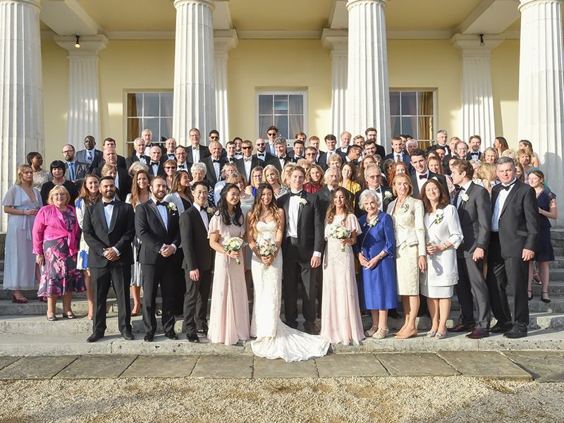 Bridal party on the steps at Stoke Place, Hertfordshire. Photography by Abigail's Studio