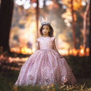 A princess in a glittering pink ball gown and crown poses in an enchanted autumn forest setting.