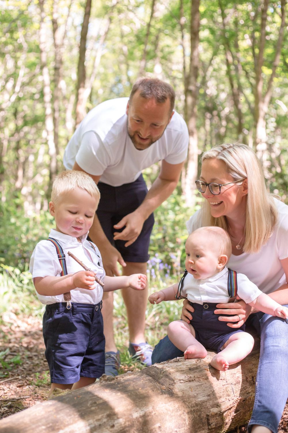 A bluebell photoshoot in the woodland at Abbots wood with a mother, father, and two sons