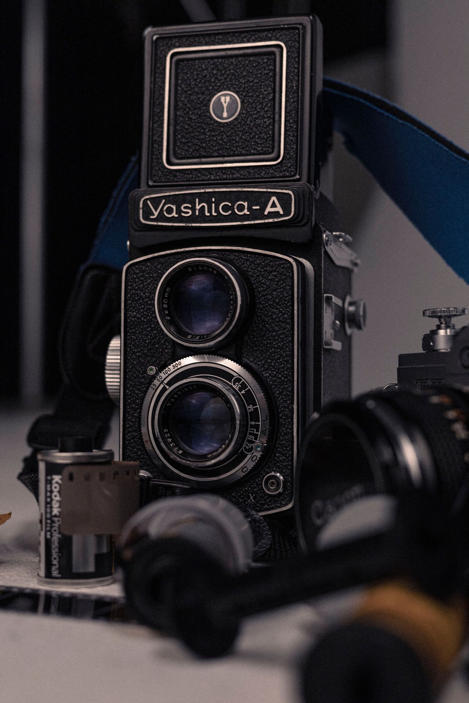 A vintage Yashica-A twin lens reflex camera photographed in dramatic lighting.