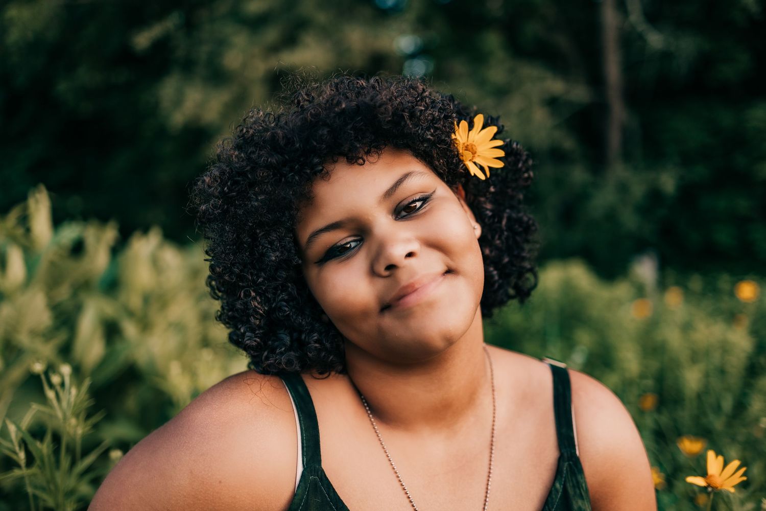 Woman with flower in her hair at the park.
