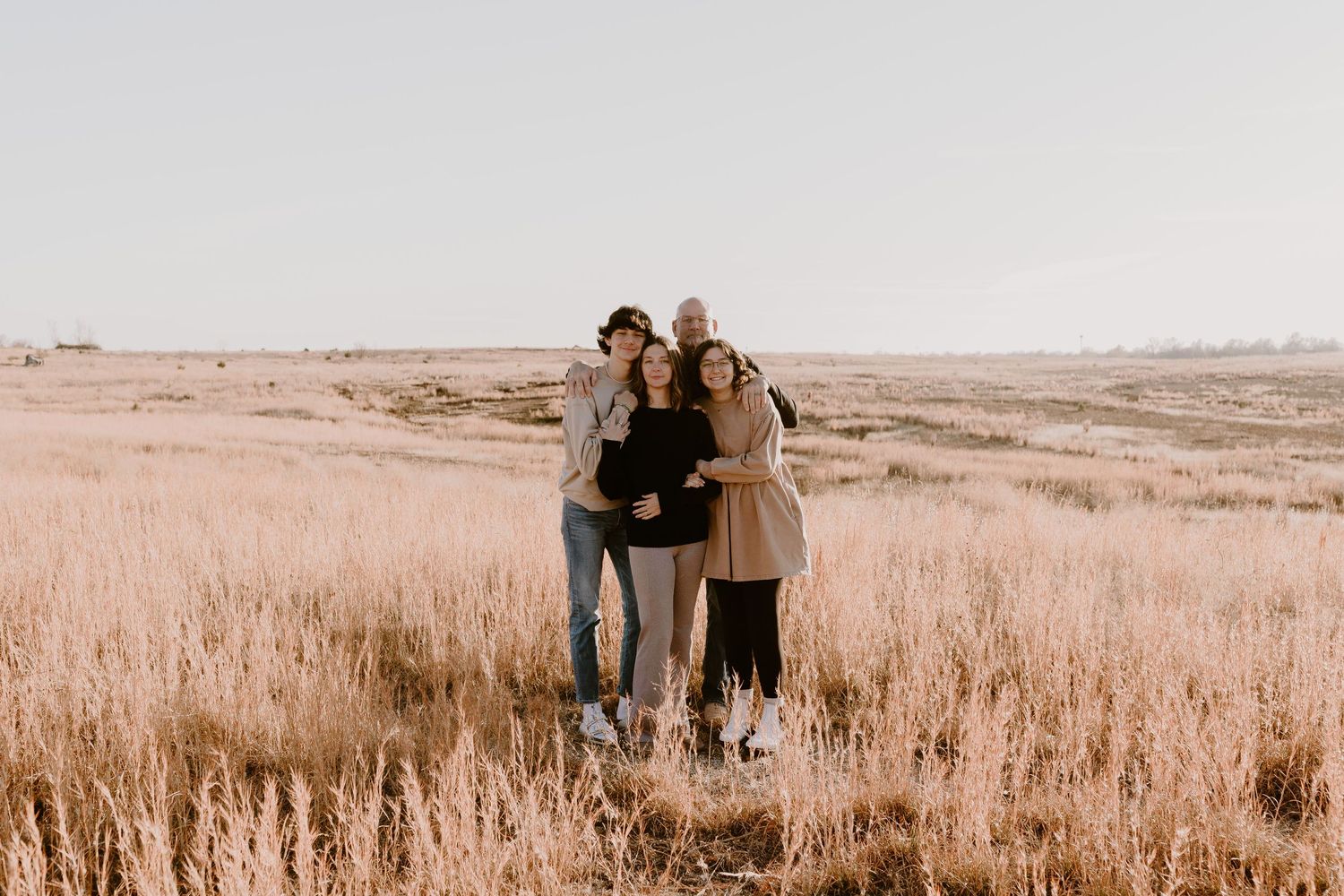 Candid family portrait in Joplin, Missouri captured in natural light by Modern Moods Imagery, showing genuine connection and movement.