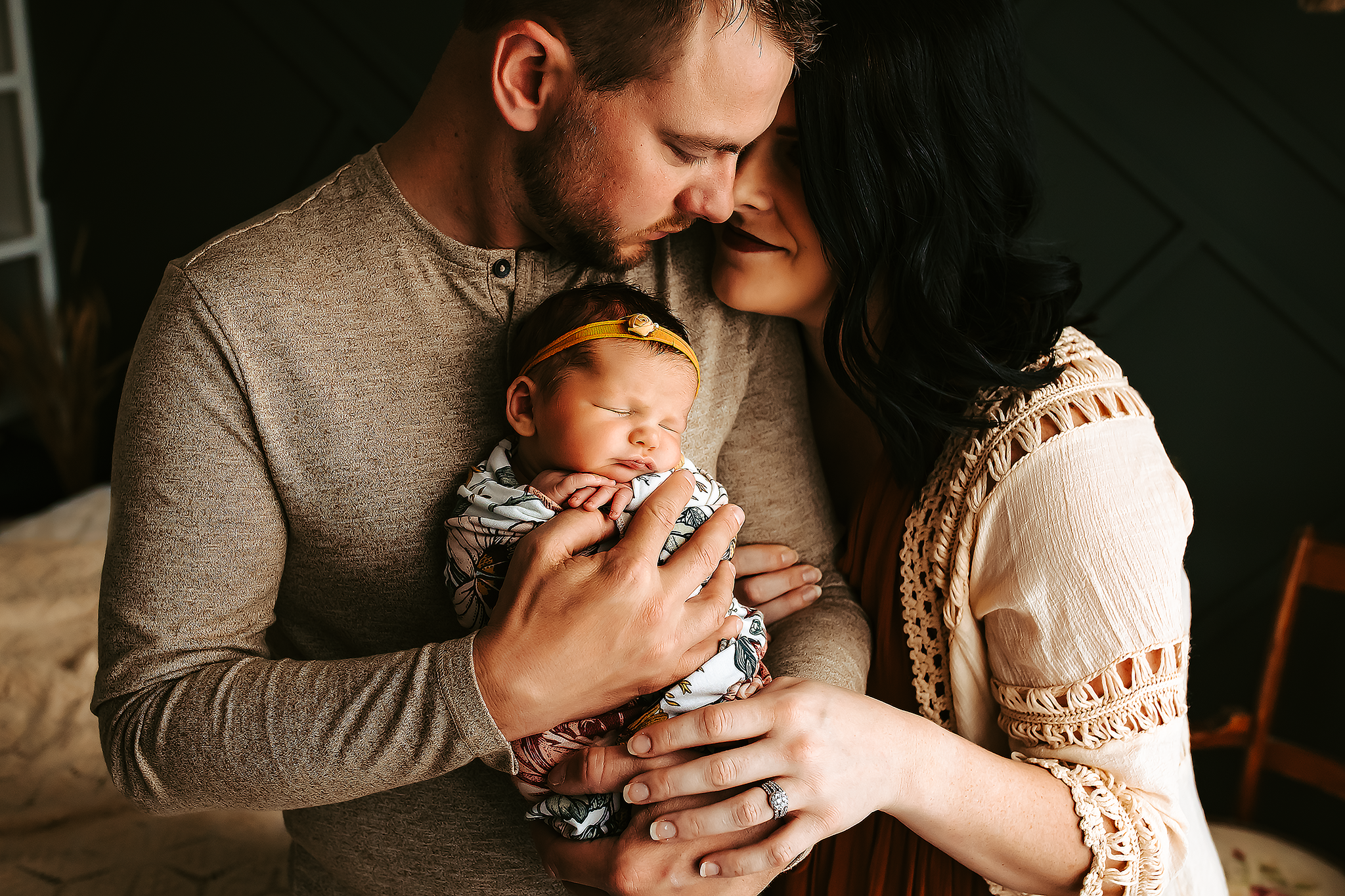 Parents holding newborn in cozy lifestyle session – Columbia Missouri newborn photography