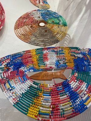 Rainbow-colored beaded disc artwork with fish motif displaying vibrant patterns and detailed craftsmanship.