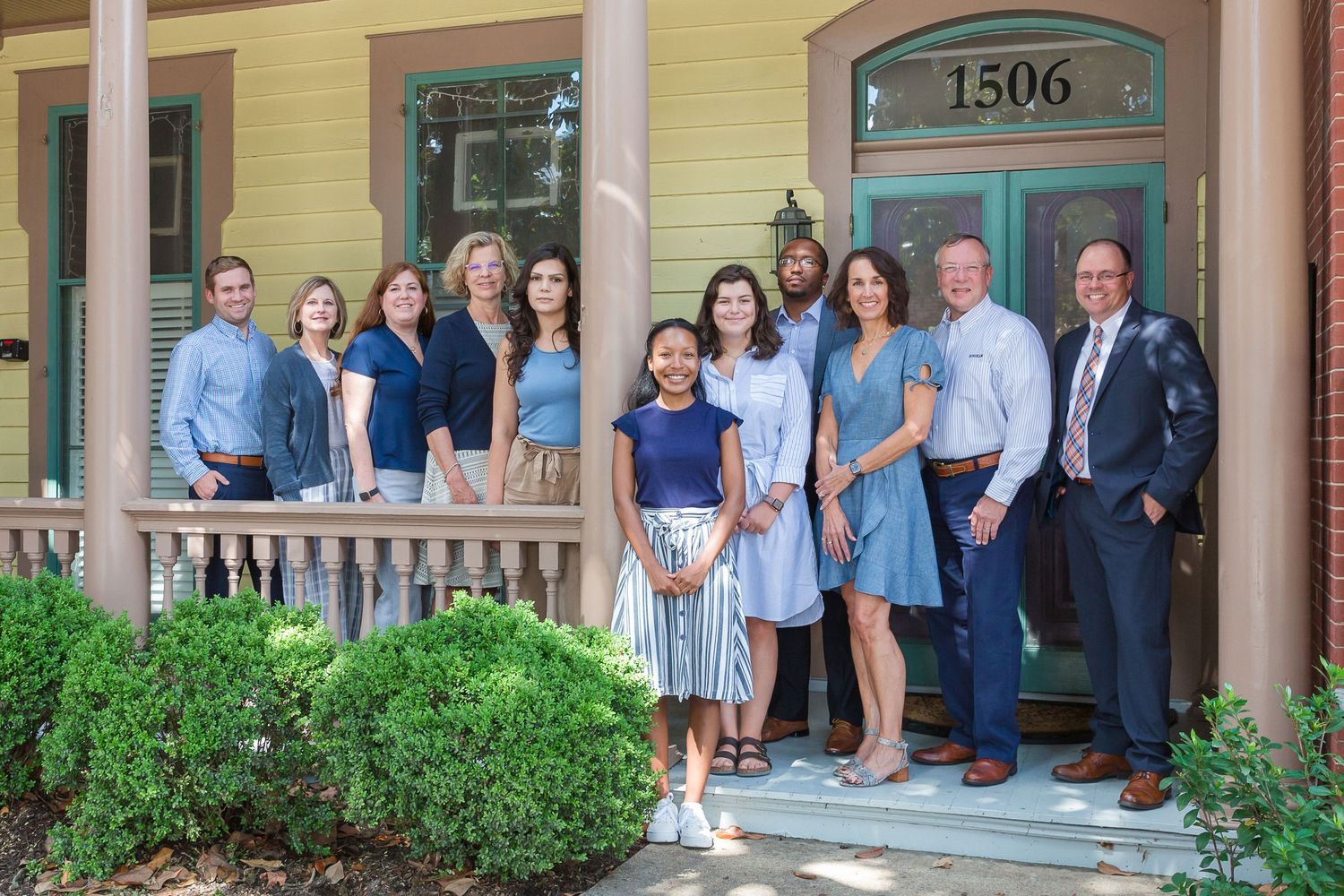 team photo on front porch of office site
