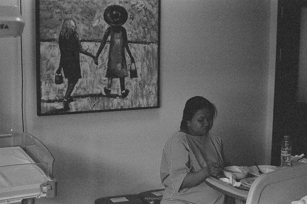 Interior room with artwork on wall showing framed photograph of figures walking together.