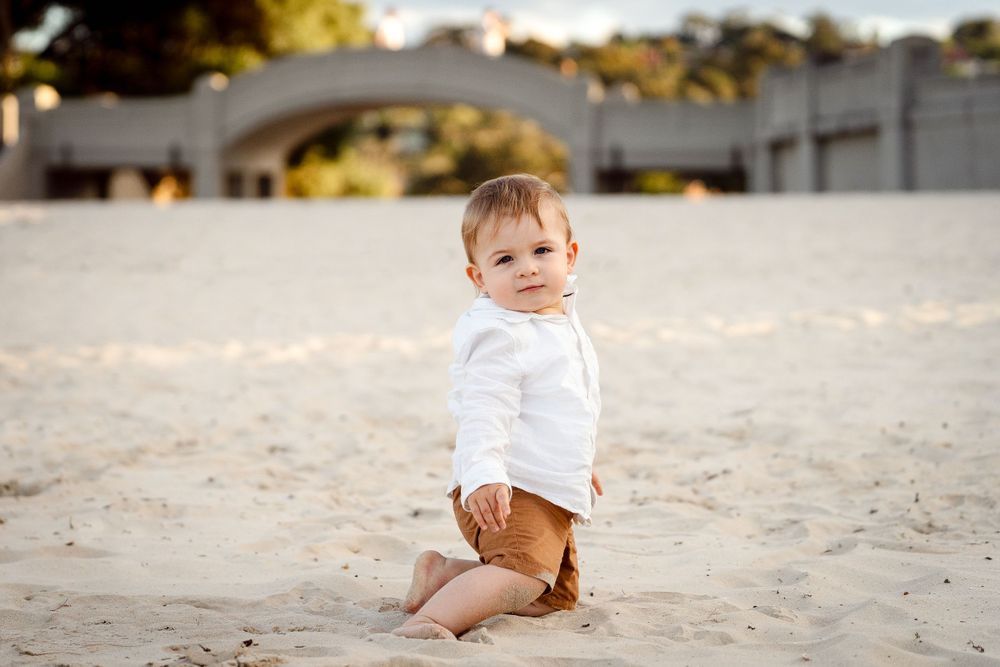baby boy posing for camera on Balmoral beach