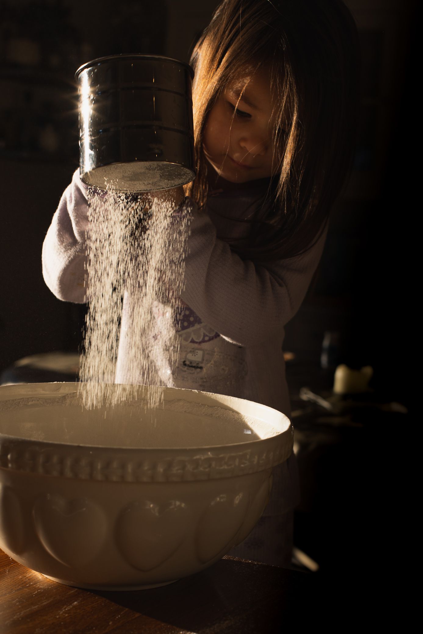 Girl baking at home in Barnet with gorgeous winter light