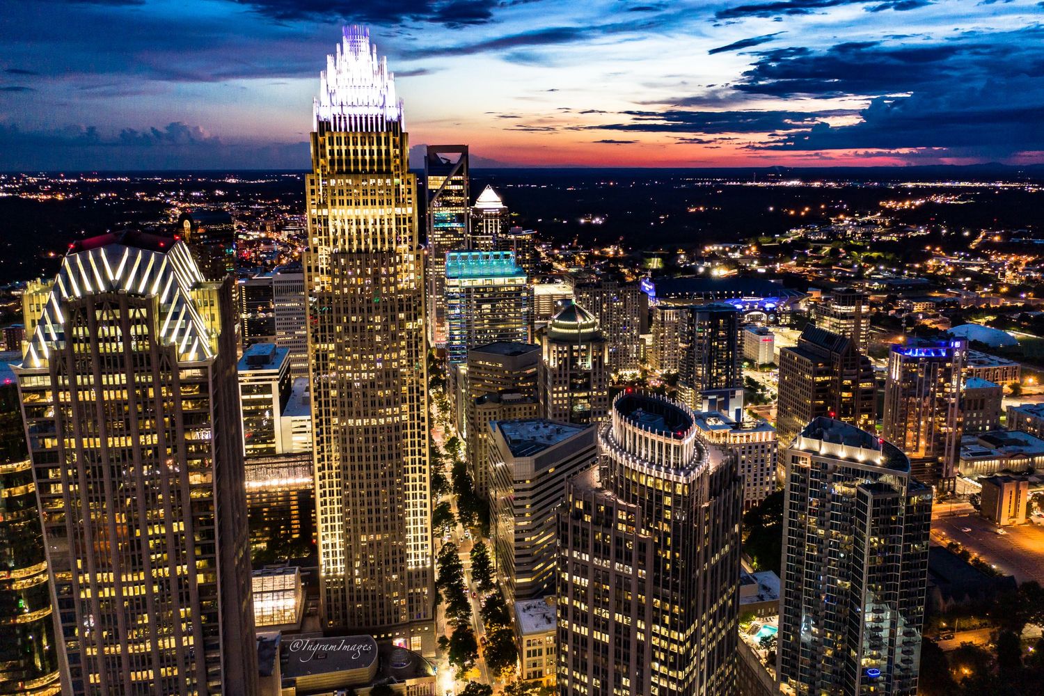 Aerial view of Charlotte skyline at sunset.