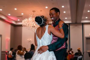 Bride and groom smiling at each other during first dance