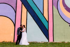Bride and groom kissing in front of kenosha mural