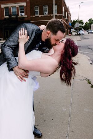 groom dipping bride and kissing in downtown kenosha