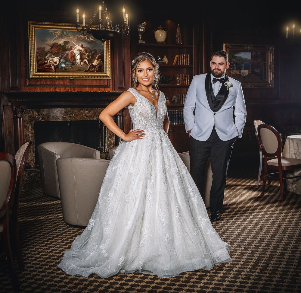 bride and groom standing in the fireplace room of a hotel, in the style of wealthy portraiture, kevin hill