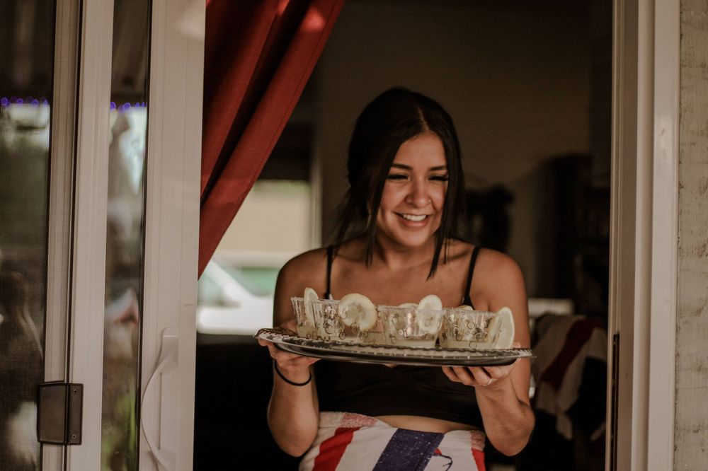 A young woman photographed holding a tray of lemon drops at a bachelorette party