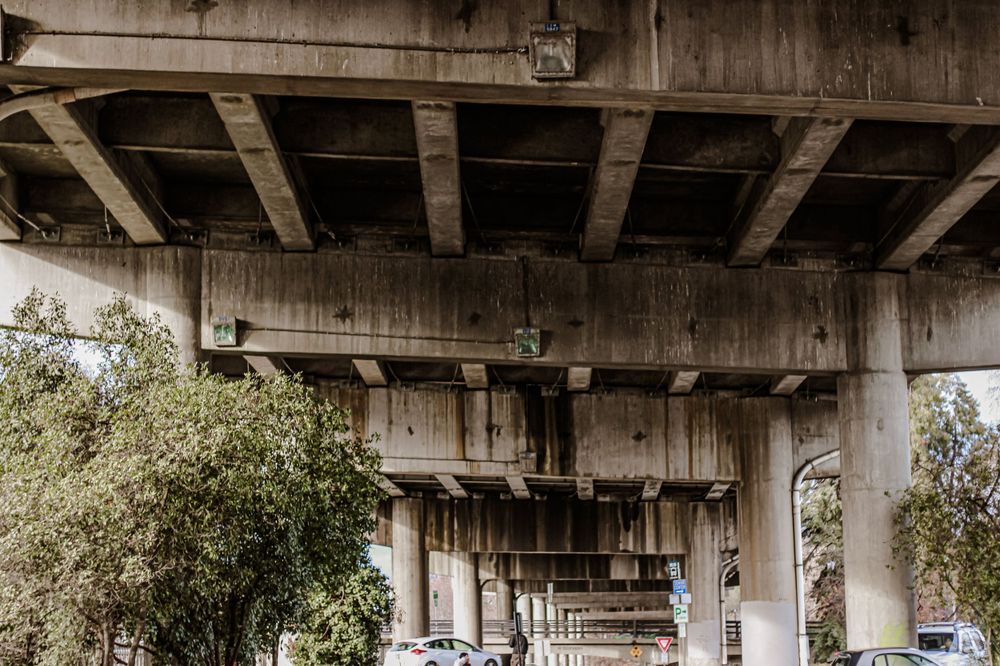 A photograph of the underneath of a bridge overpass during a community resource event