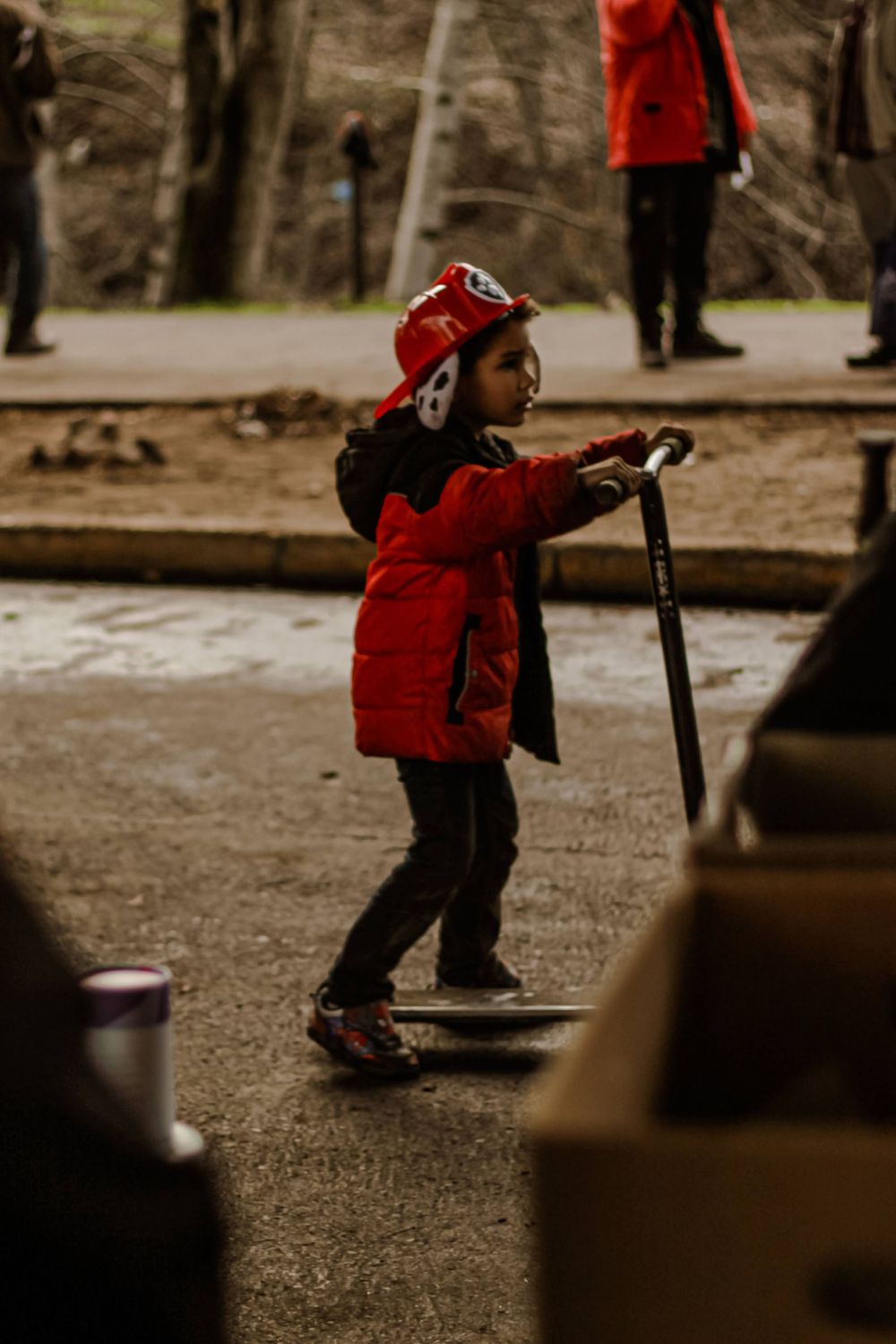 A child rolls by on his scooter