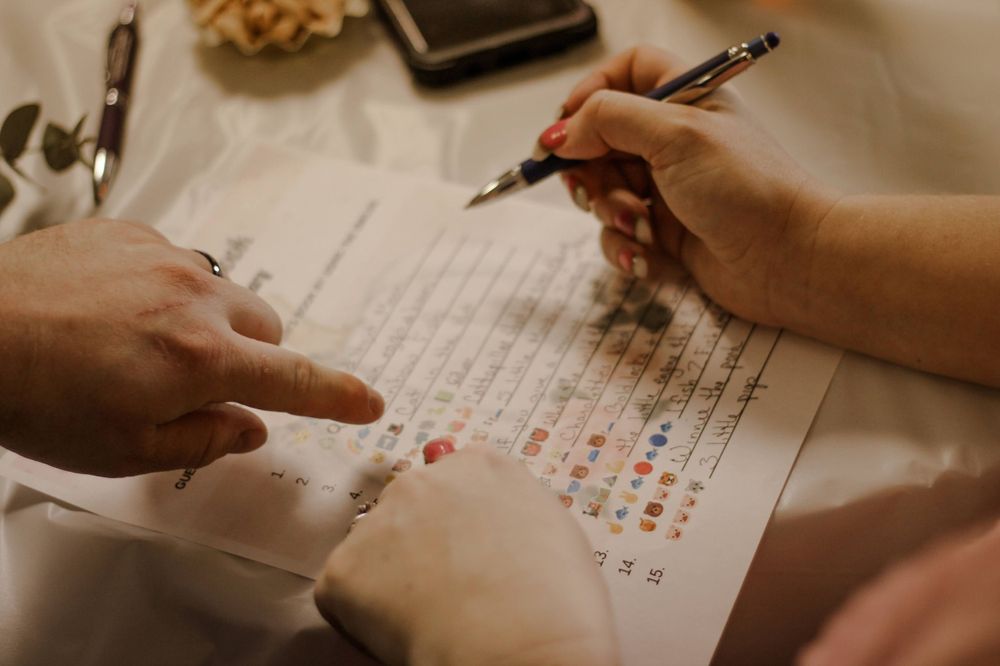 Many fingers point to discuss a baby shower game