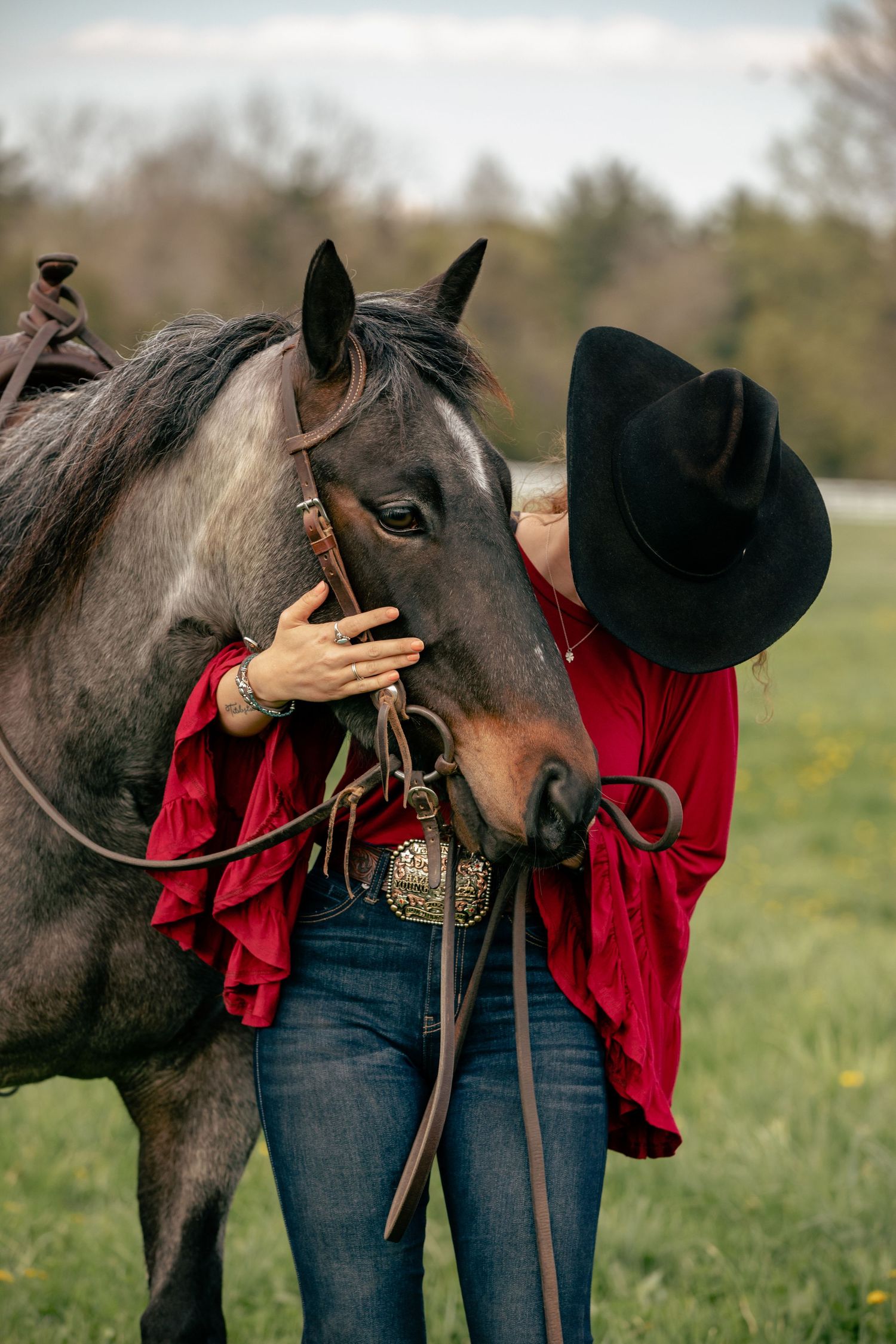 Rider holding horse's head looking down
