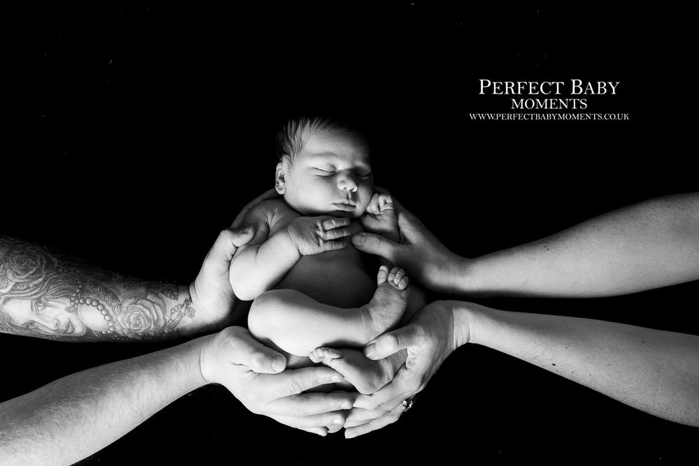 4 hands are better than Two in this newborn photo