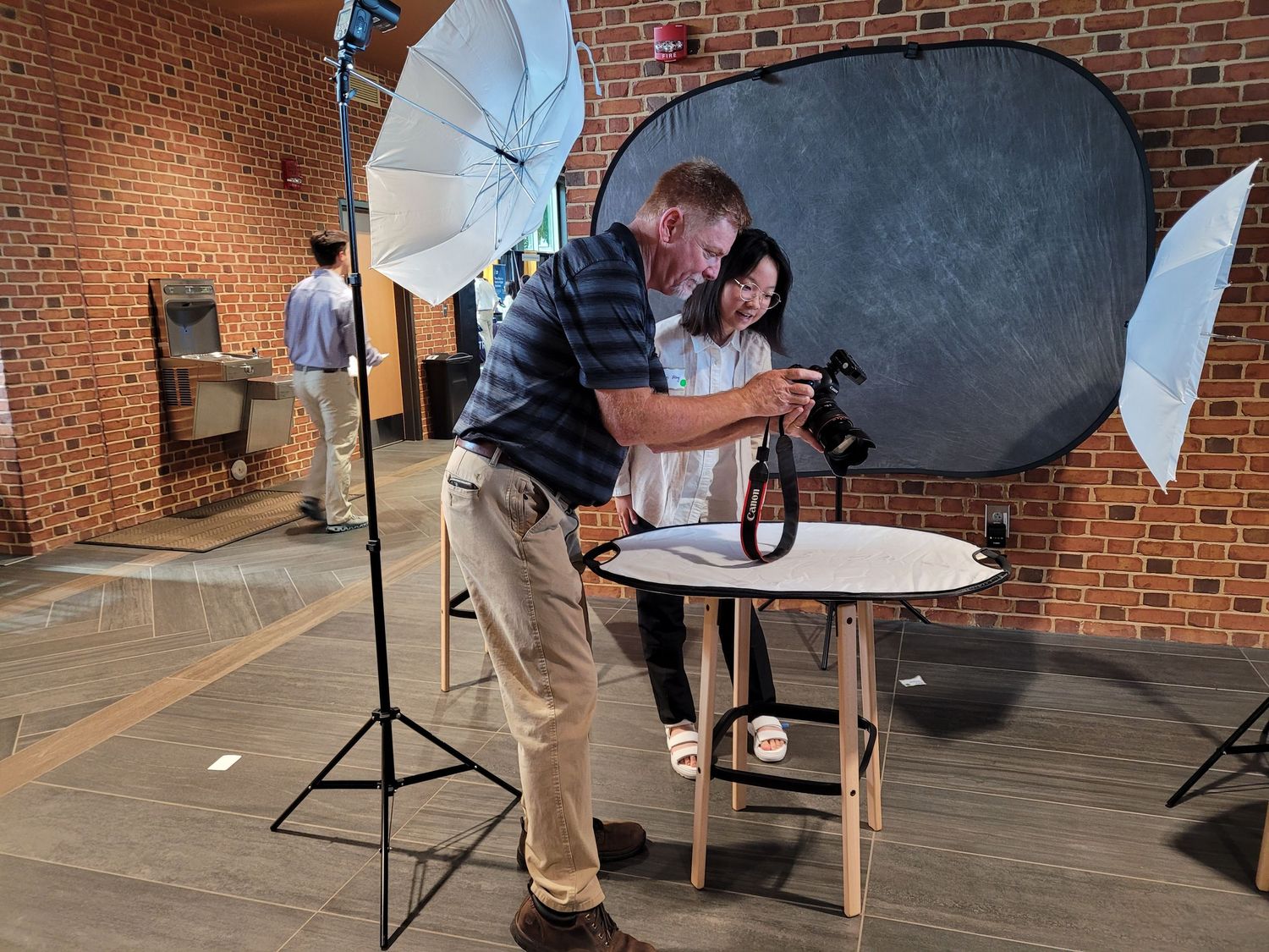Photographer reviewing headshot images with a client