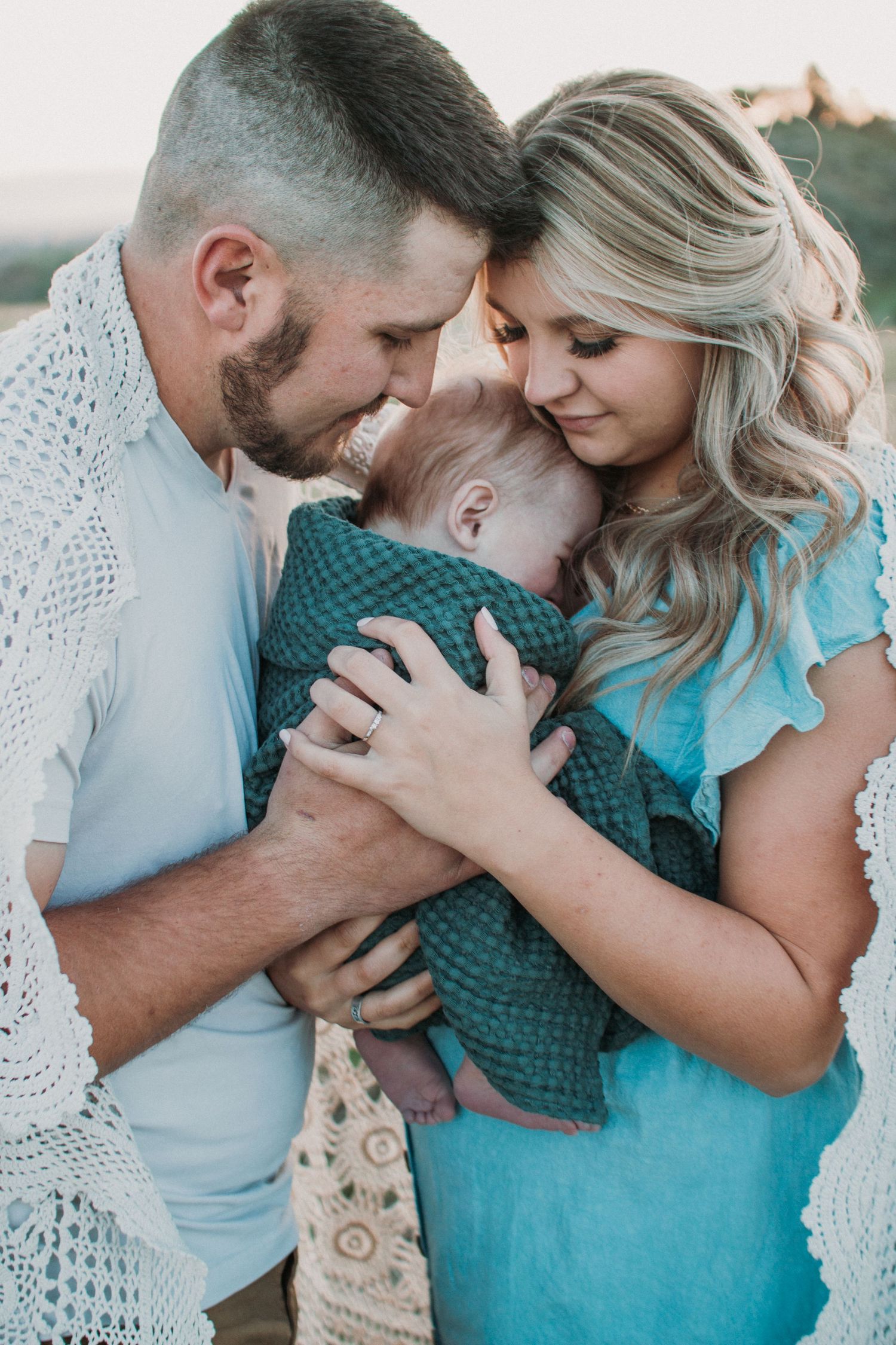 Romantic couple in turquoise outfits sharing tender moments in a series of intimate photos.