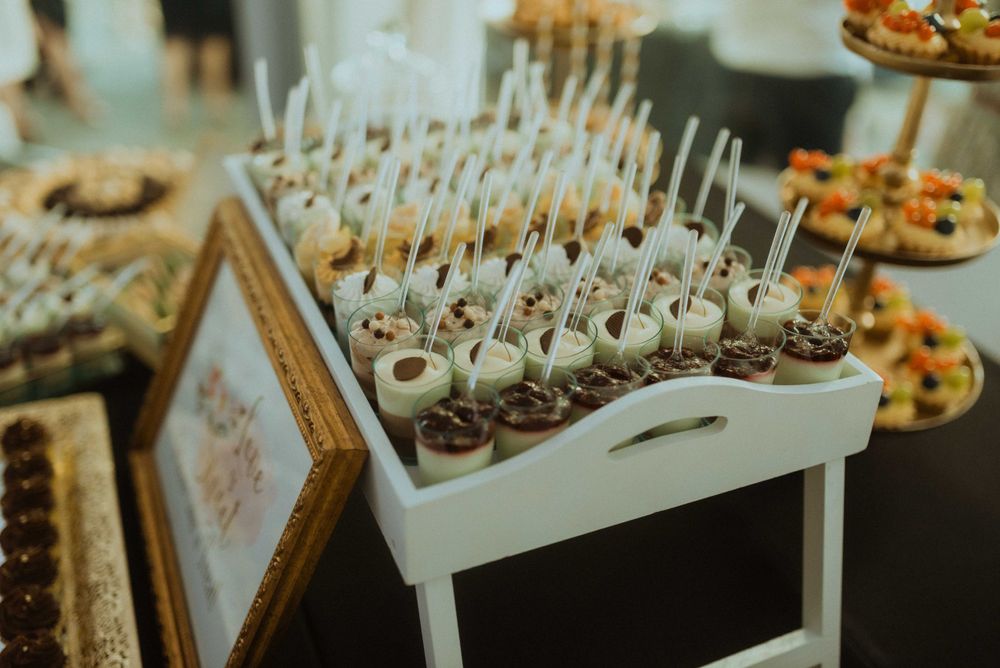 White display tray filled with chocolate-dipped cake pops at dessert table.