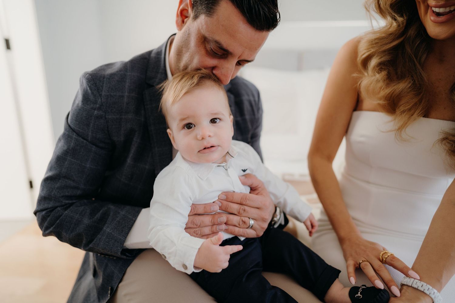 a dad holds his son before his christening