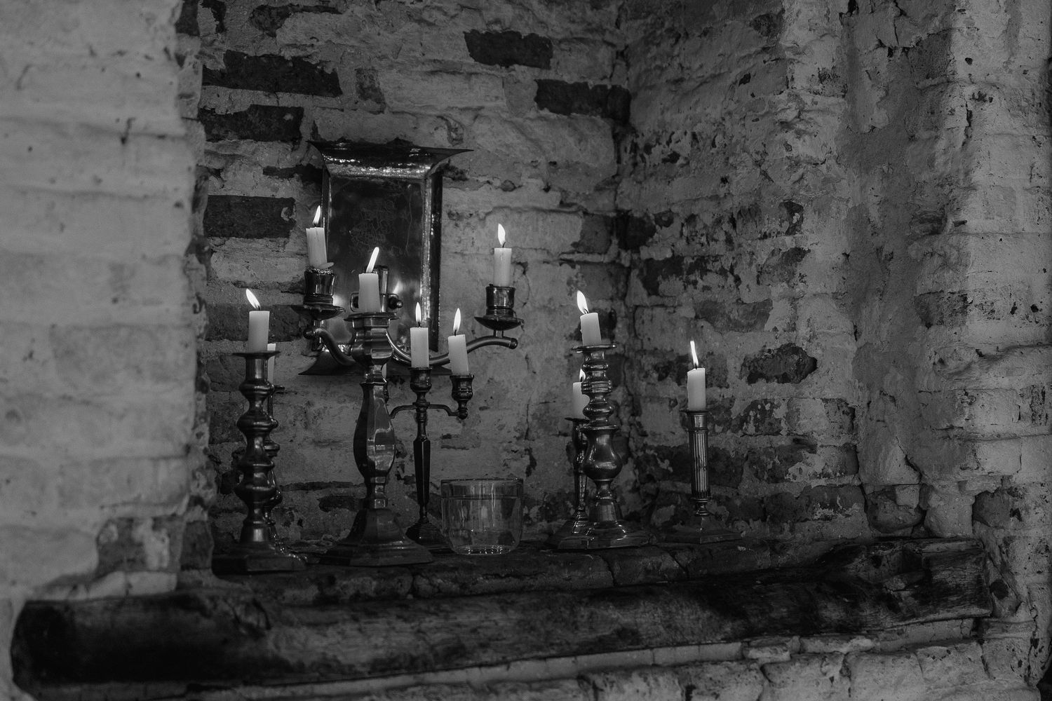 a candelabra sitting in a brick alcove.