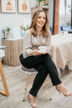 Professional lifestyle photoshoot in modern office setting showing casual business attire and relaxed seating.