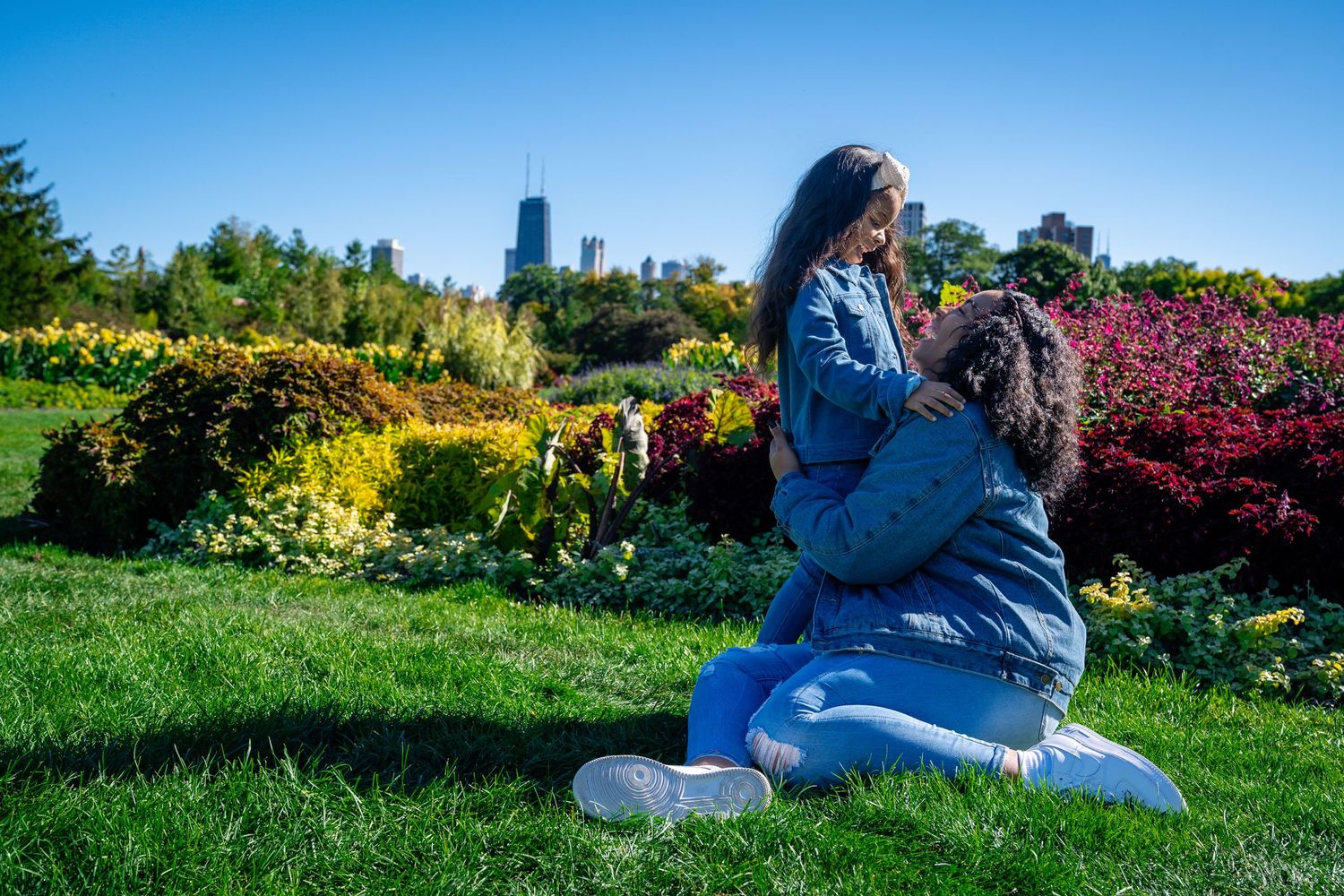 A photographer captures images in a colorful garden with Chicago skyline in background.
