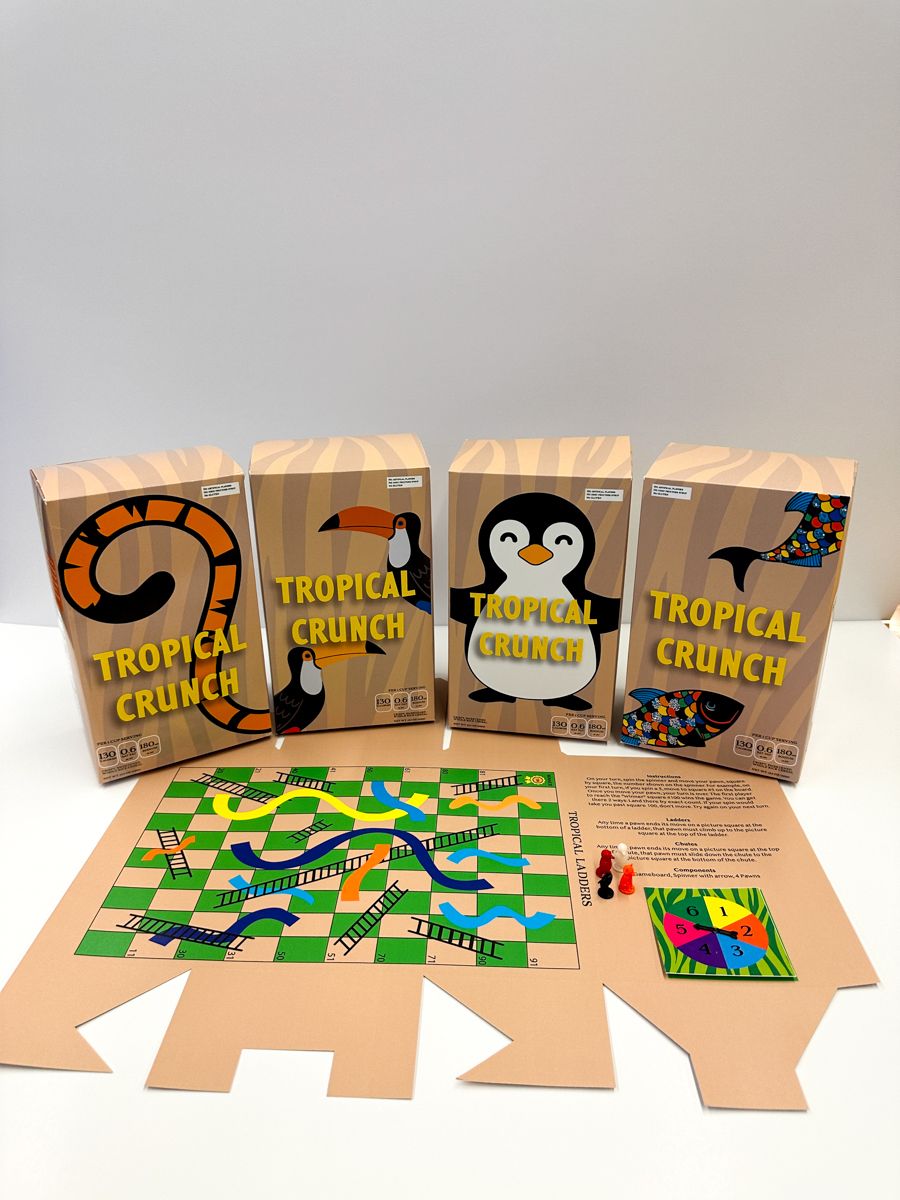 Four retail boxes of Tropical Crunch cereal with penguin mascot and board game components displayed.