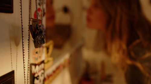 Blurred close-up shot of jewelry or necklaces hanging in soft focus.