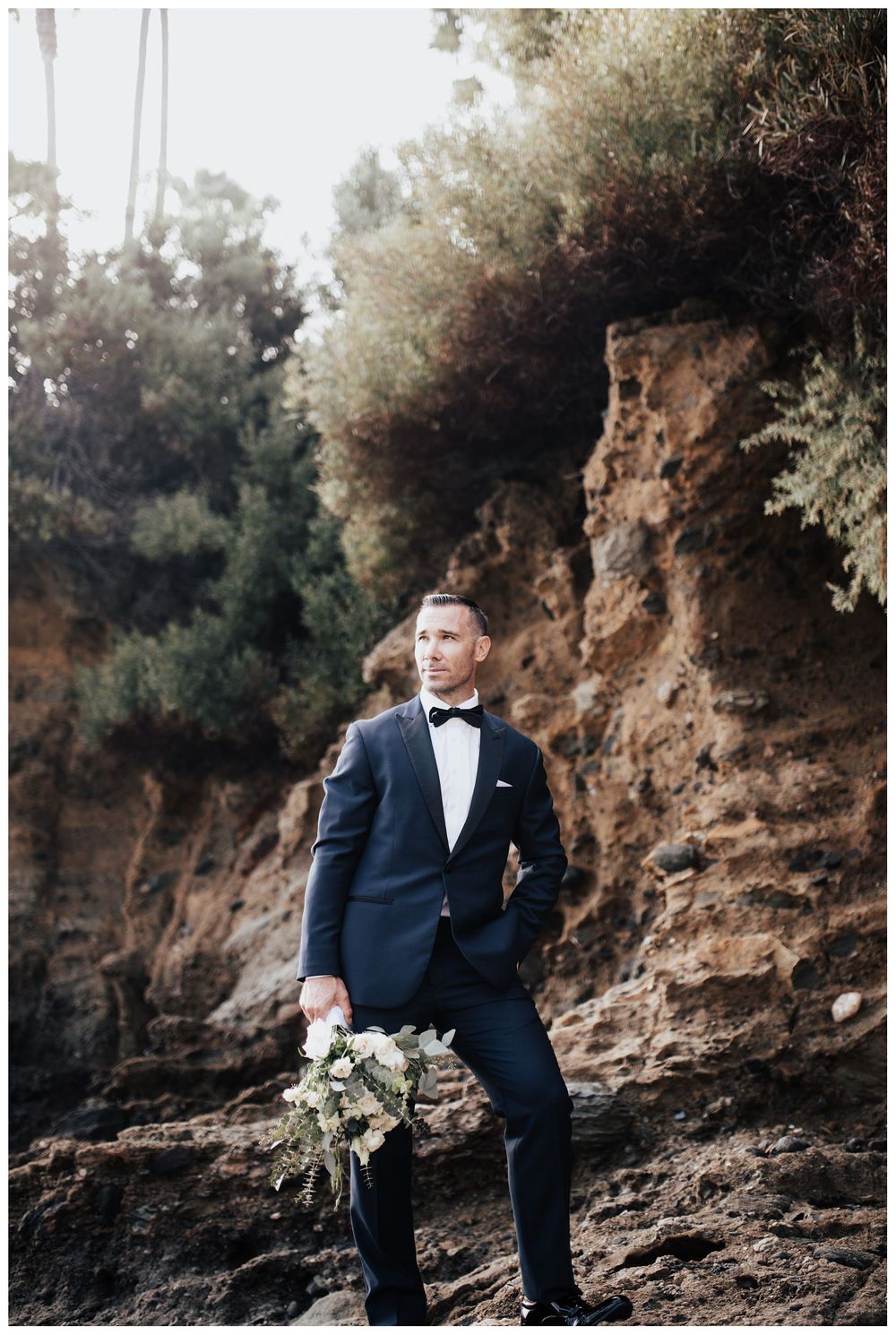 groom on beach, groom holding bouquet, groom wedding photos