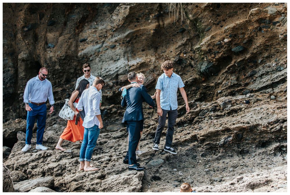 guests walking to elopement, wedding guests on beach