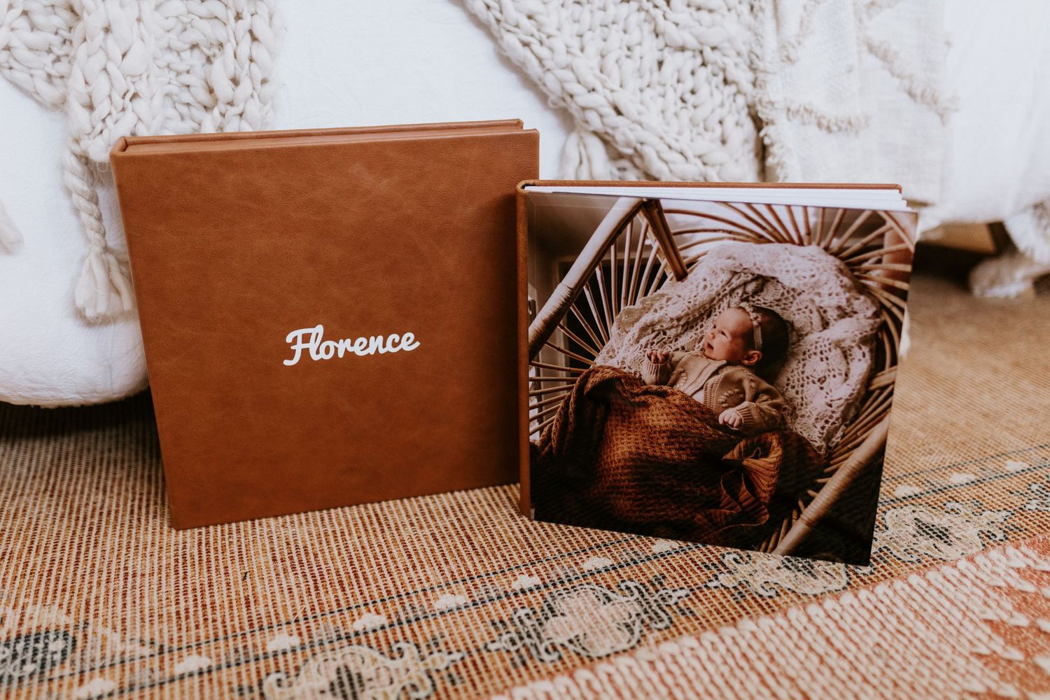 Collection of leather-bound photo albums arranged on textured surface.
