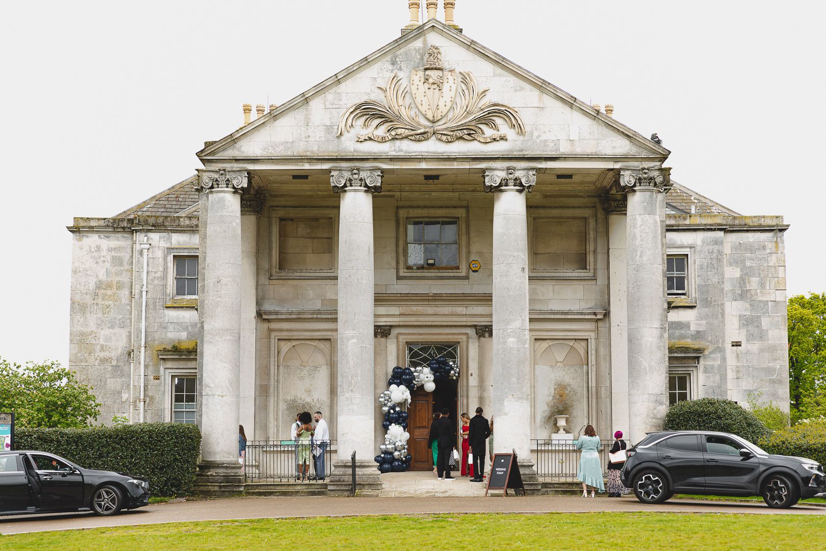 Grand neoclassical wedding venue with white columns and elegant architecture.