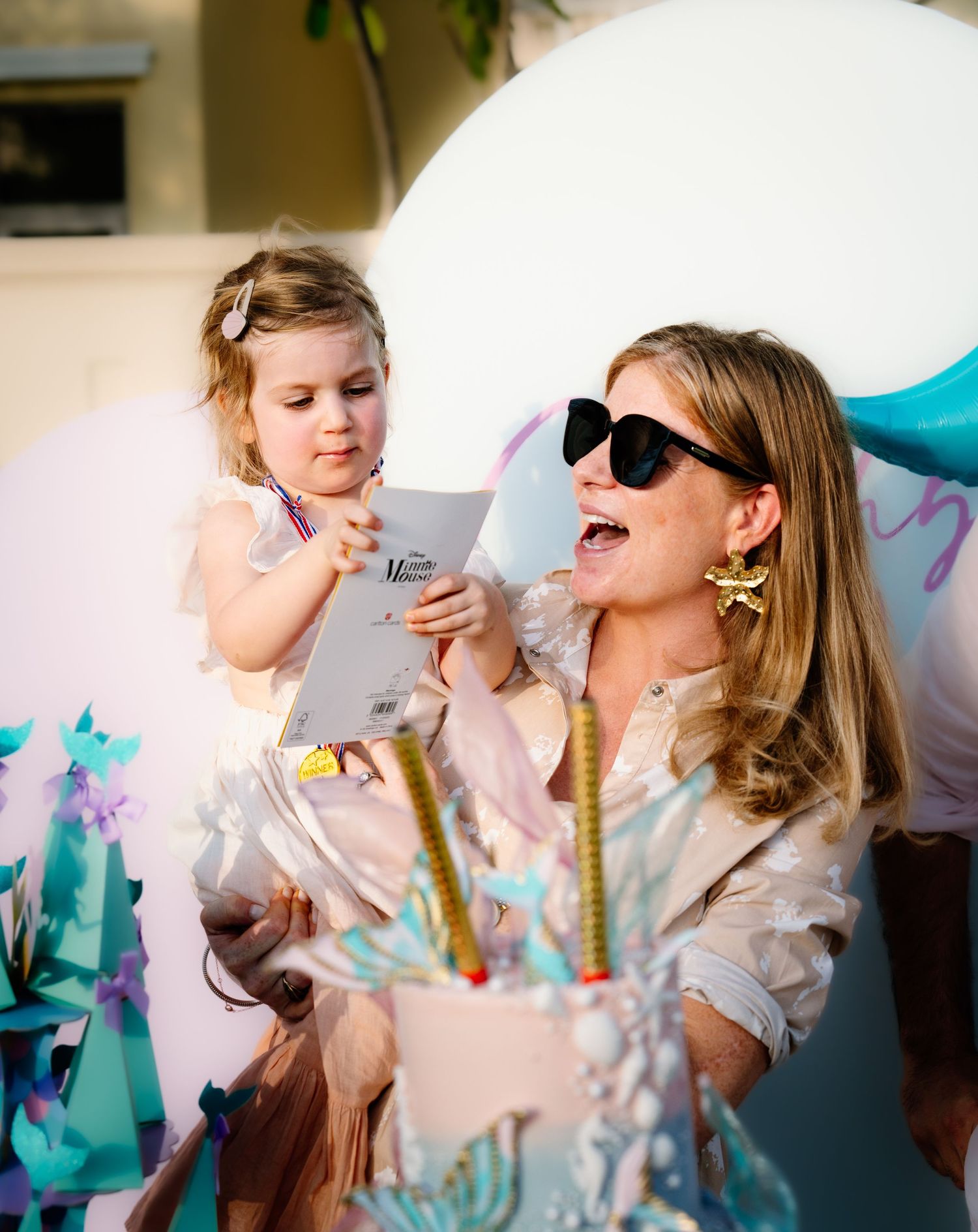 Group celebration with balloons and confetti creating a festive party atmosphere in bright colors.