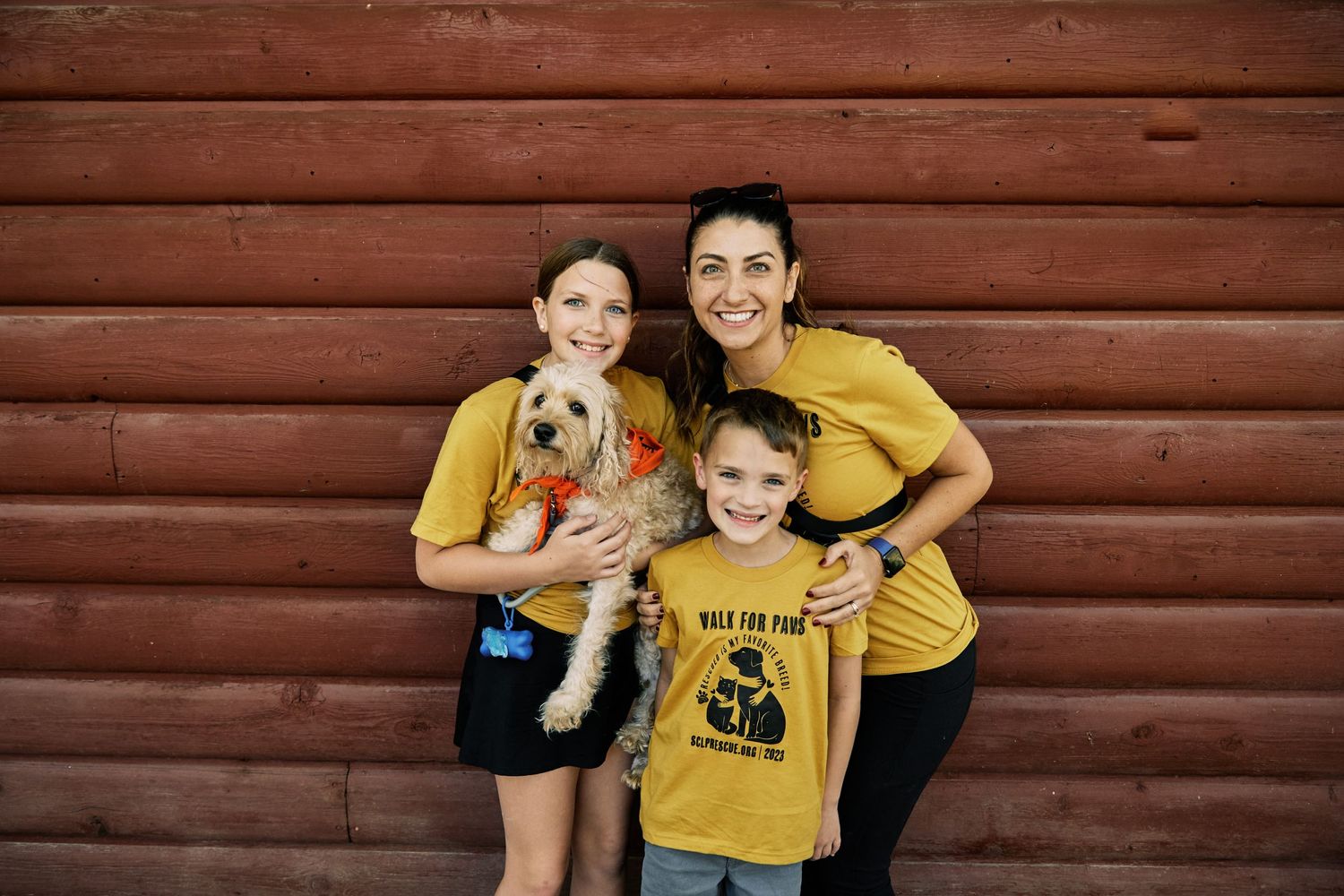Family wearing matching yellow shirts sharing joyful moments together.